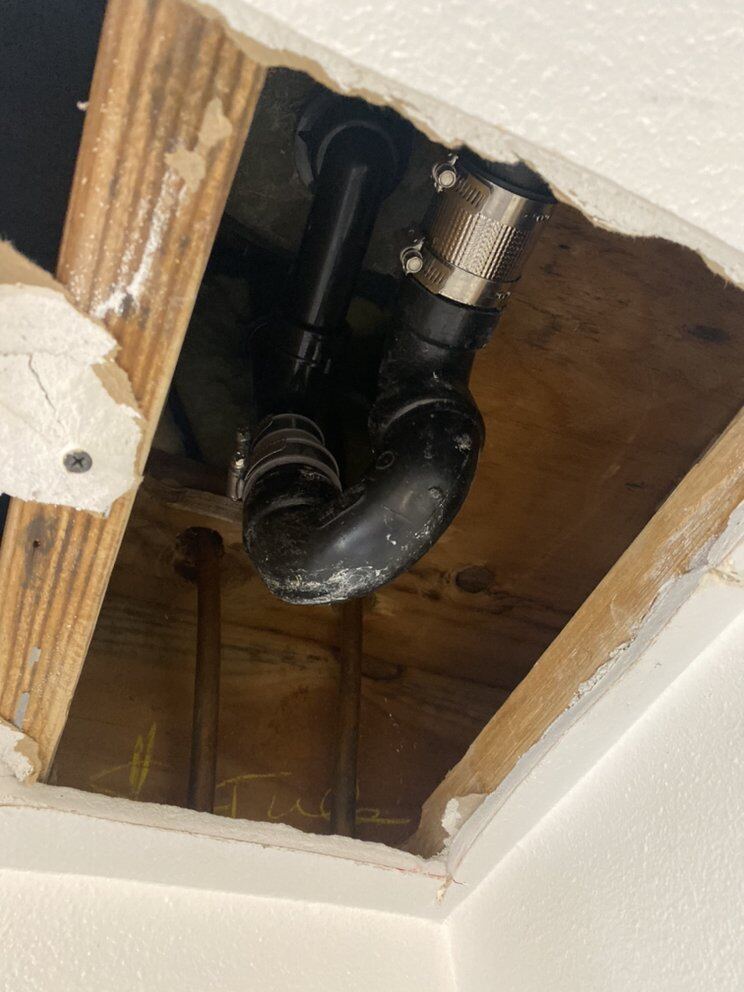 Drain reached through a ceiling opening