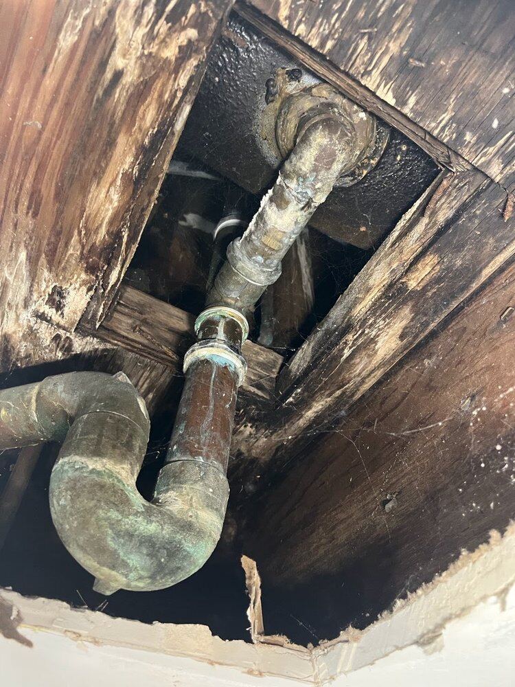Corroded lines exposed through a ceiling