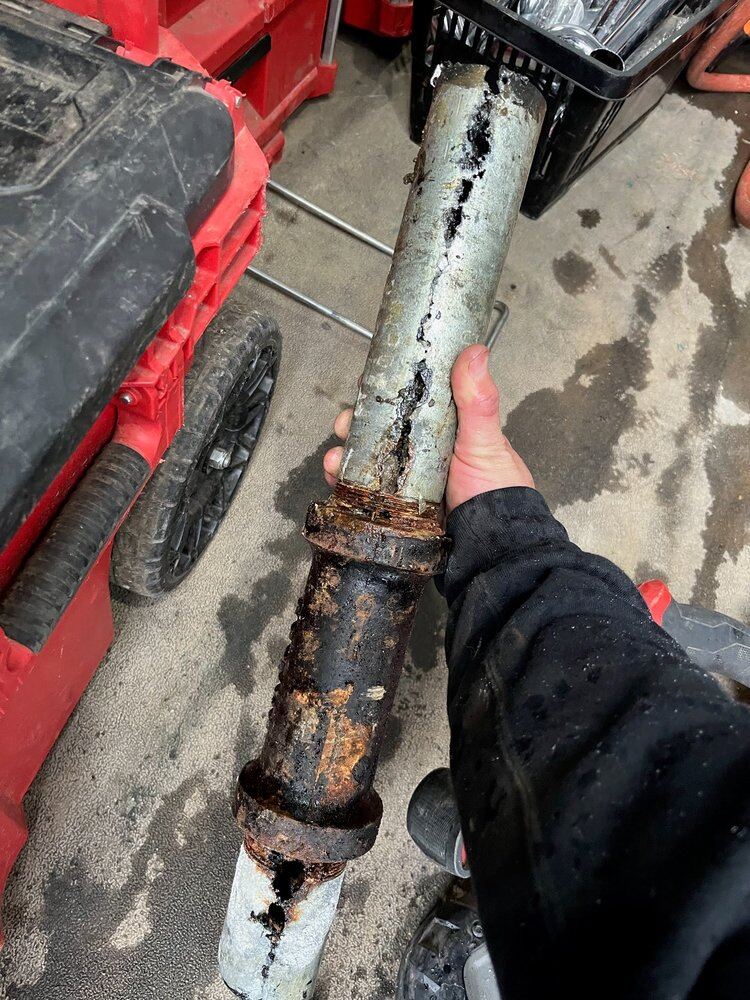 Removed section — corrosion opened the pipe wall